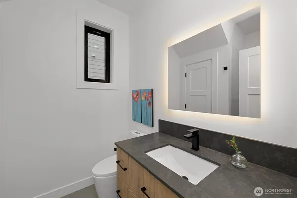 a bathroom with a sink double vanity and a mirror