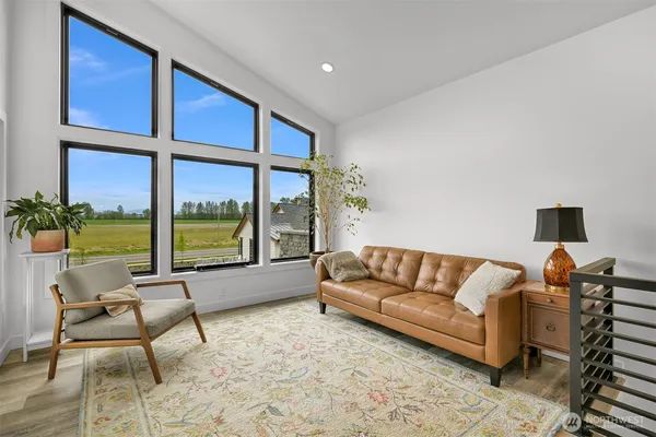a living room with furniture and kitchen view