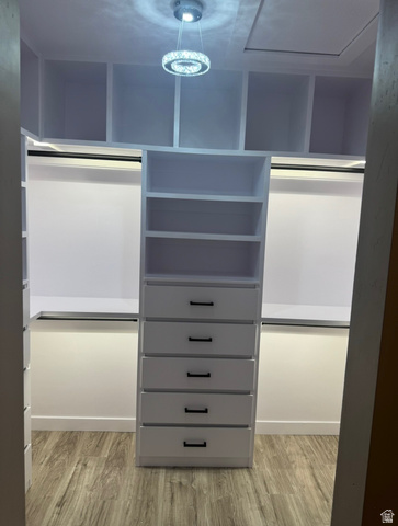 1787 North 1280 East Payson, UT 84651 - Photo 18 of 22 Custom closet system featuring multiple open shelves, built-in drawers with black hardware, and hanging rods