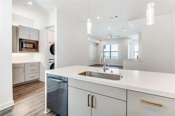 a utility room with sink dryer and washer