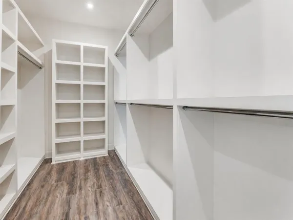 a view of a room with wooden floor and a bathroom