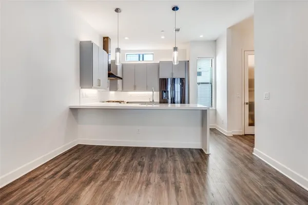 a view of kitchen with wooden floor and window