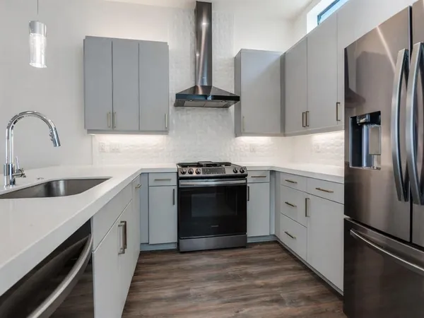 a kitchen with stainless steel appliances a refrigerator stove and sink
