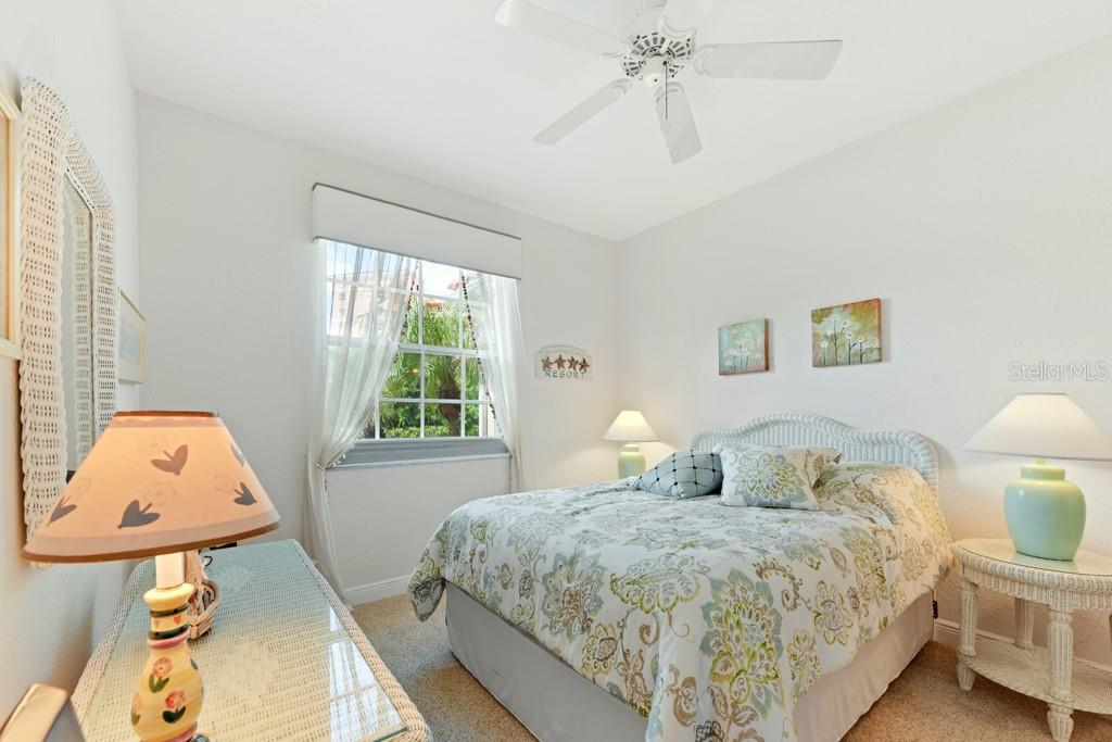 3181 Matecumbe Key Road, Unit 32 Punta Gorda, FL 33955 - Photo 25 of 42 a bedroom with a bed a window and dresser