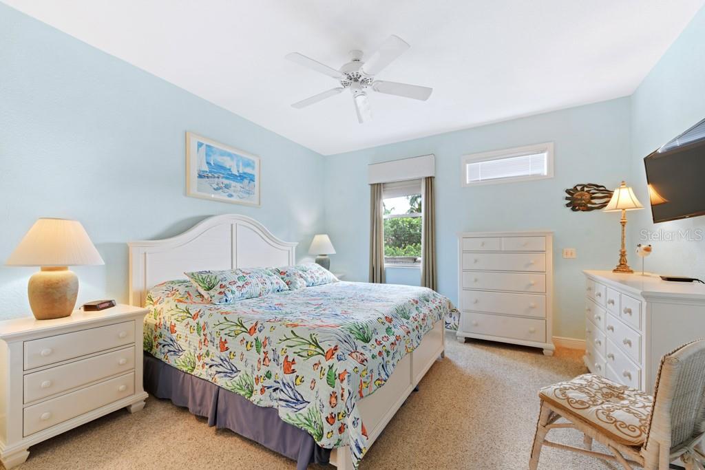 3181 Matecumbe Key Road, Unit 32 Punta Gorda, FL 33955 - Photo 26 of 42 a bedroom with a bed and a chandelier