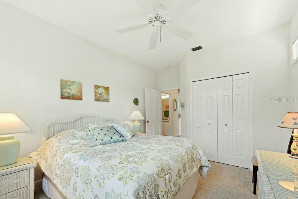 3181 Matecumbe Key Road, Unit 32 Punta Gorda, FL 33955 - Photo 31 of 42 a bedroom with a bed and a table