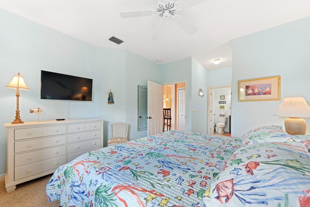 3181 Matecumbe Key Road, Unit 32 Punta Gorda, FL 33955 - Photo 32 of 42 a bedroom with a bed and a flat screen tv in it