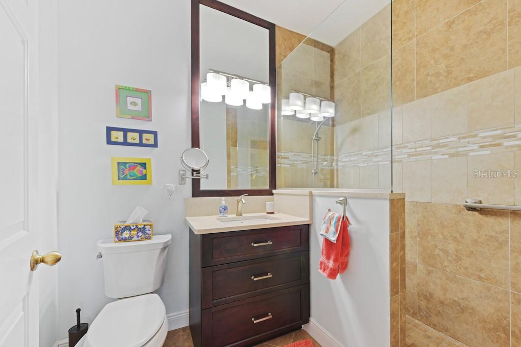 3181 Matecumbe Key Road, Unit 32 Punta Gorda, FL 33955 - Photo 33 of 42 a bathroom with a sink vanity mirror and toilet