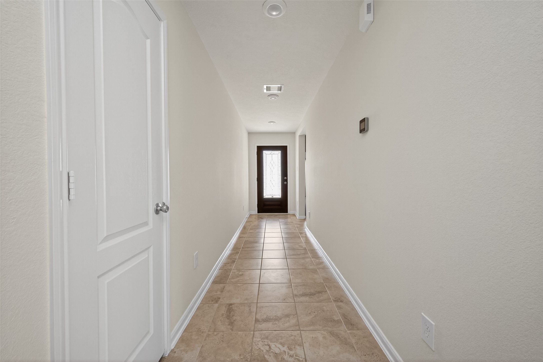 2754 Cayden Creek Way Conroe, TX 77304 - Photo 4 of 40 a view of a hallway with wooden floor and a bathroom
