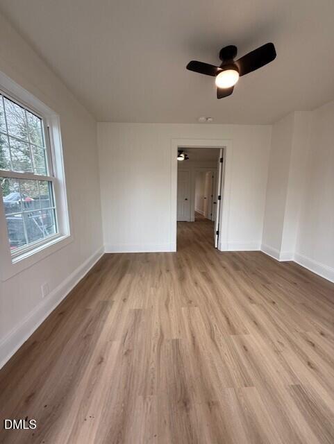 103 Broughton Street Garner, NC 27529 - Photo 4 of 15 wooden floor in an empty room with a window