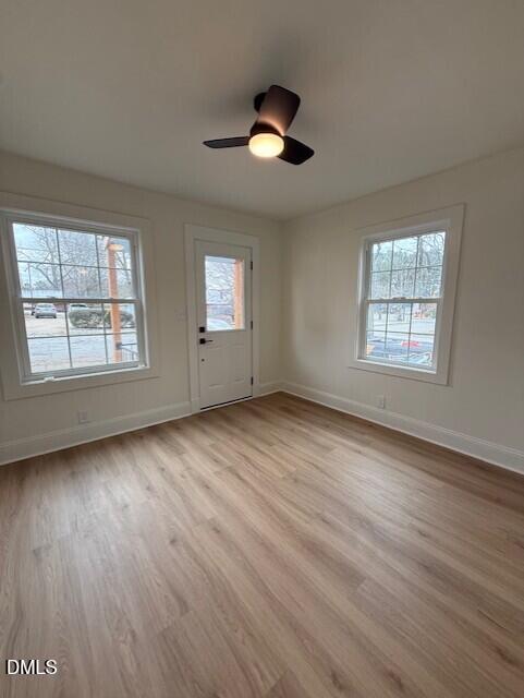 103 Broughton Street Garner, NC 27529 - Photo 6 of 15 an empty room with wooden floor and windows
