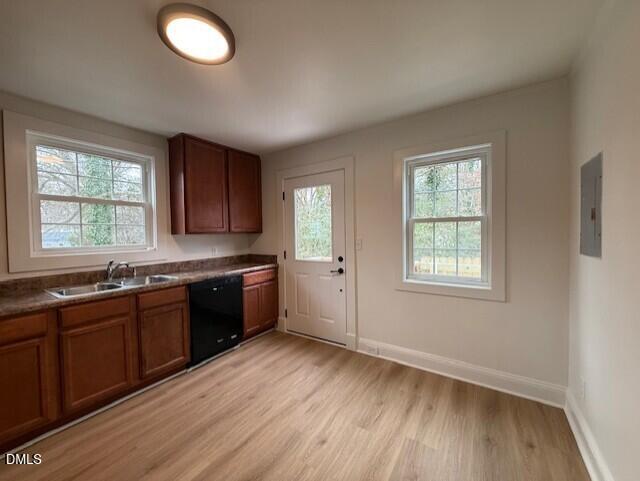 103 Broughton Street Garner, NC 27529 - Photo 7 of 15 a large kitchen with granite countertop a stove a sink a window and wooden floor
