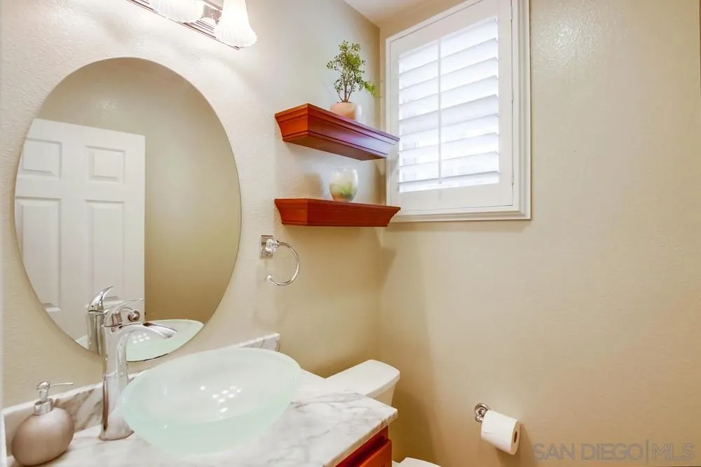 12237 Pepper Tree Lane Poway, CA 92064 - Photo 13 of 25 a bathroom with a sink and a mirror