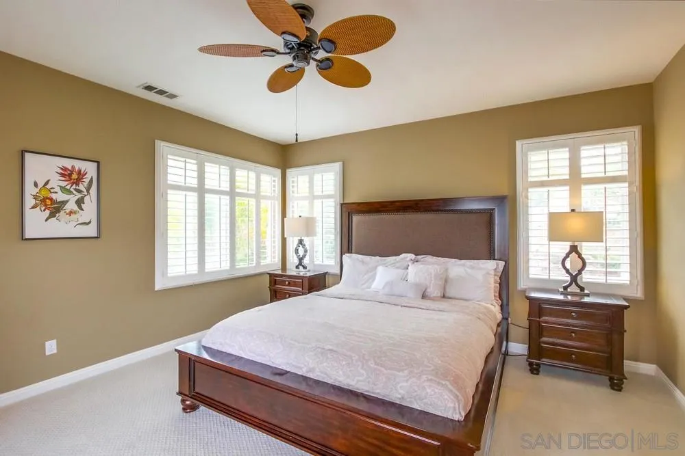 12237 Pepper Tree Lane Poway, CA 92064 - Photo 14 of 25 a bedroom with a bed and a chandelier