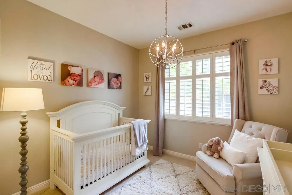 12237 Pepper Tree Lane Poway, CA 92064 - Photo 16 of 25 a bedroom with furniture and a chandelier