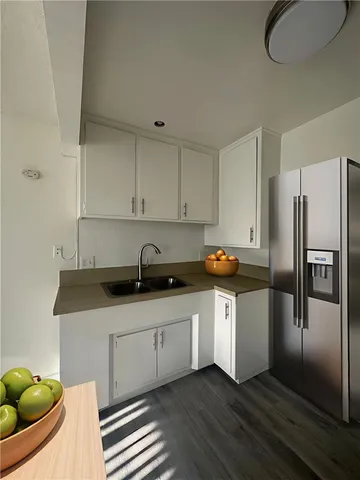 a kitchen with stainless steel appliances granite countertop a sink a stove and a refrigerator