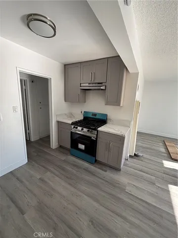 a kitchen with wooden floors and a sink