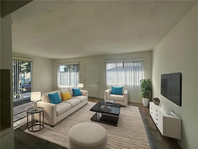 a living room with furniture flat screen tv and wooden floor
