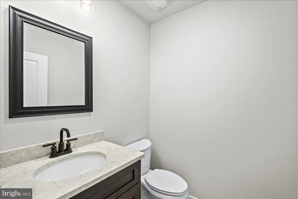 a spacious bathroom with a double vanity sink mirror and bathtub