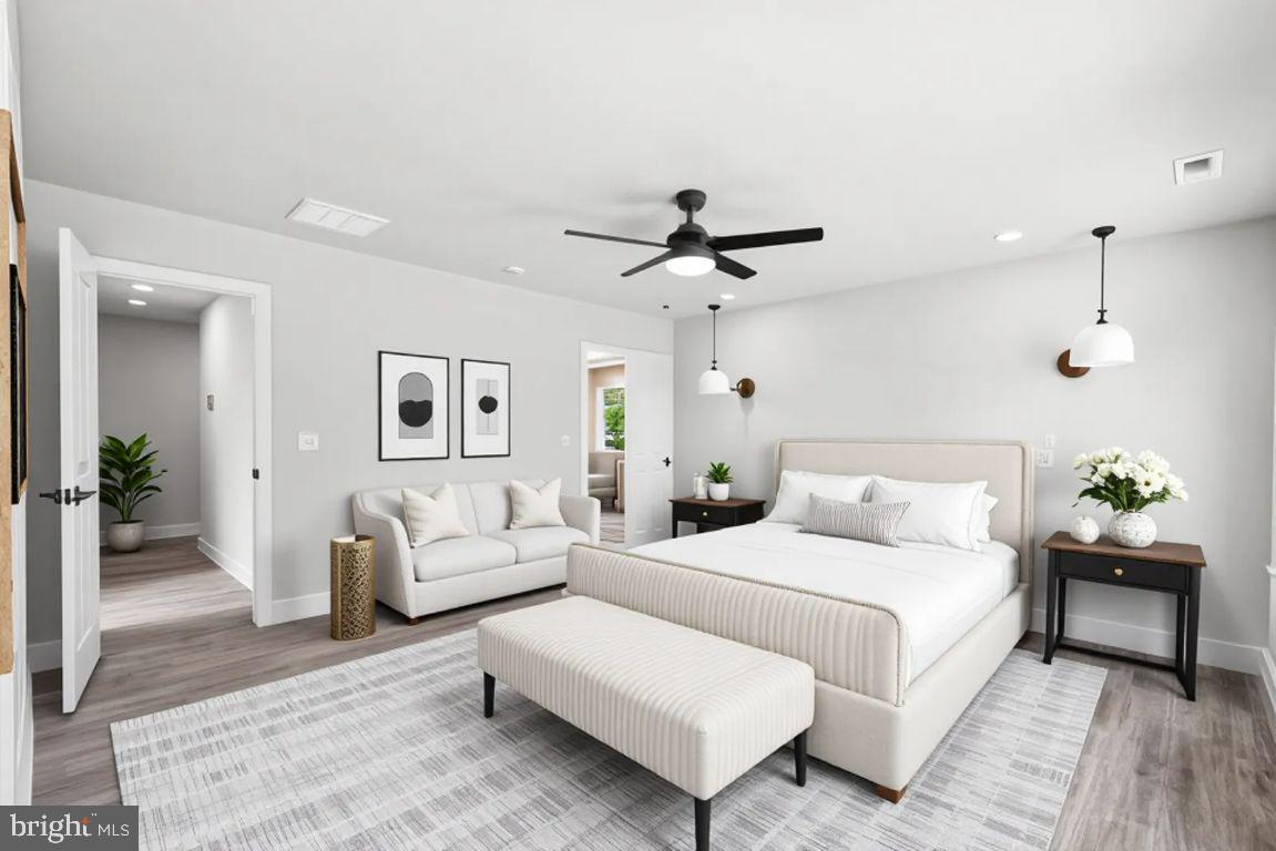 702 Taggart Street Colonial Beach, VA 22443 - Photo 21 of 64 a bedroom with a bed and ceiling fan