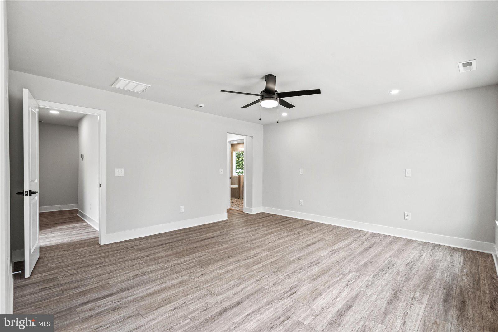 702 Taggart Street Colonial Beach, VA 22443 - Photo 22 of 64 wooden floor in an empty room with a window