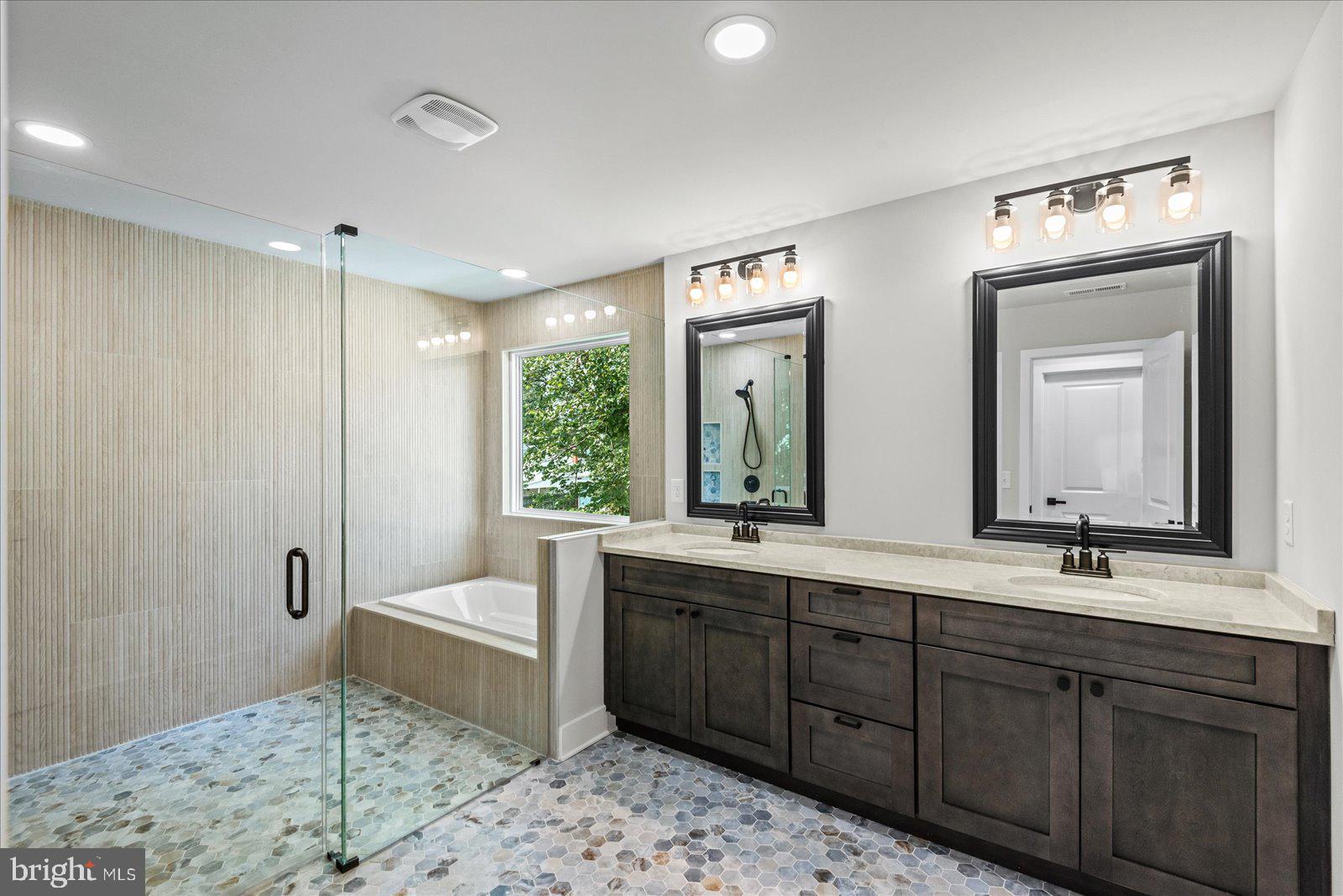 702 Taggart Street Colonial Beach, VA 22443 - Photo 25 of 64 a spacious bathroom with a double vanity sink mirror and bathtub
