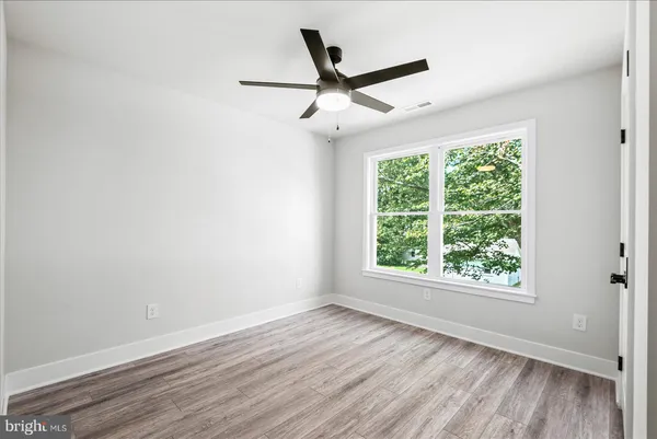 a view of a house with backyard and a tree