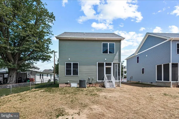 an aerial view of residential houses with outdoor space and street view