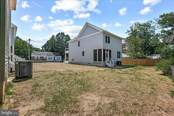 an aerial view of residential houses with outdoor space and street view