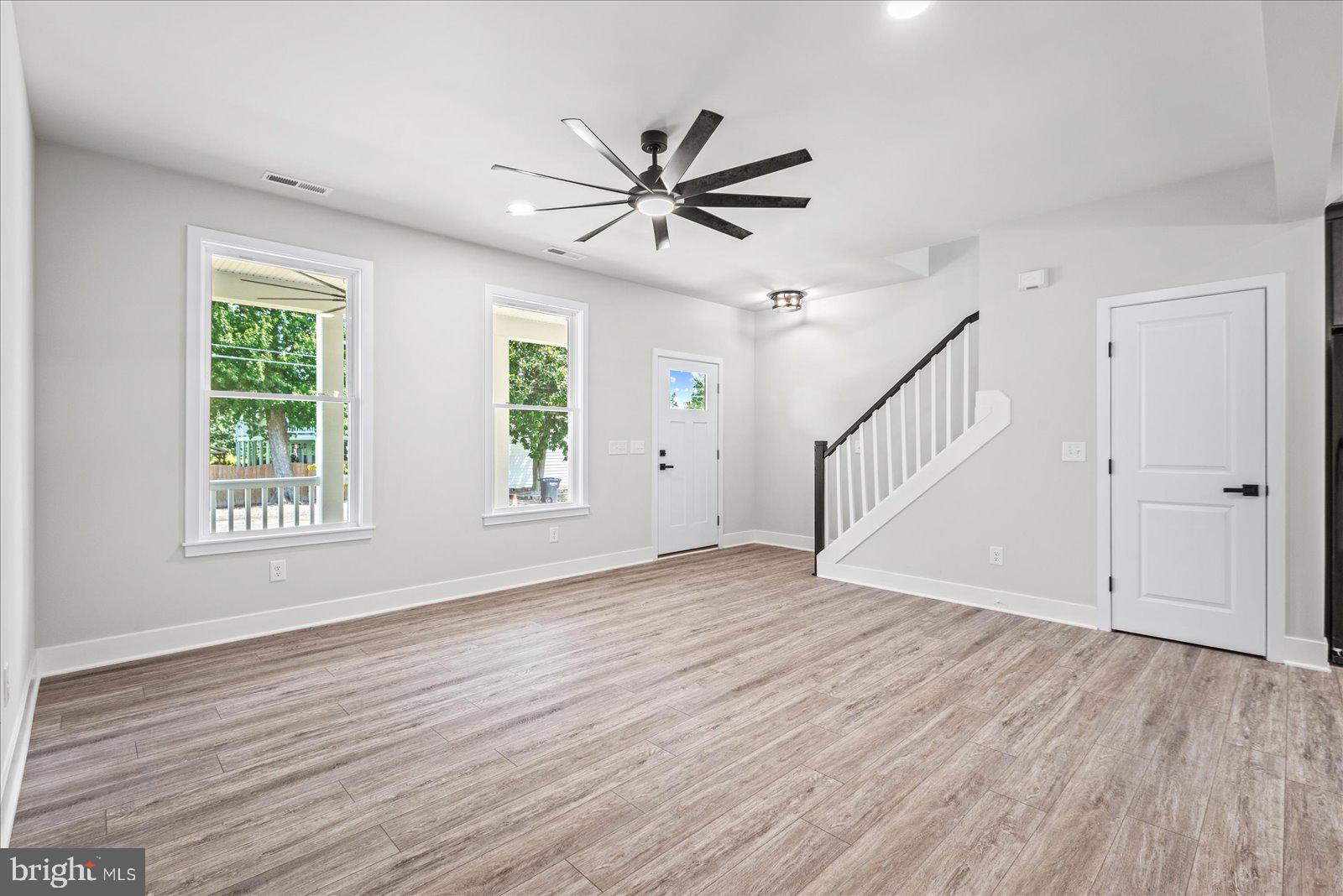 702 Taggart Street Colonial Beach, VA 22443 - Photo 7 of 64 a view of empty room with wooden floor and fan