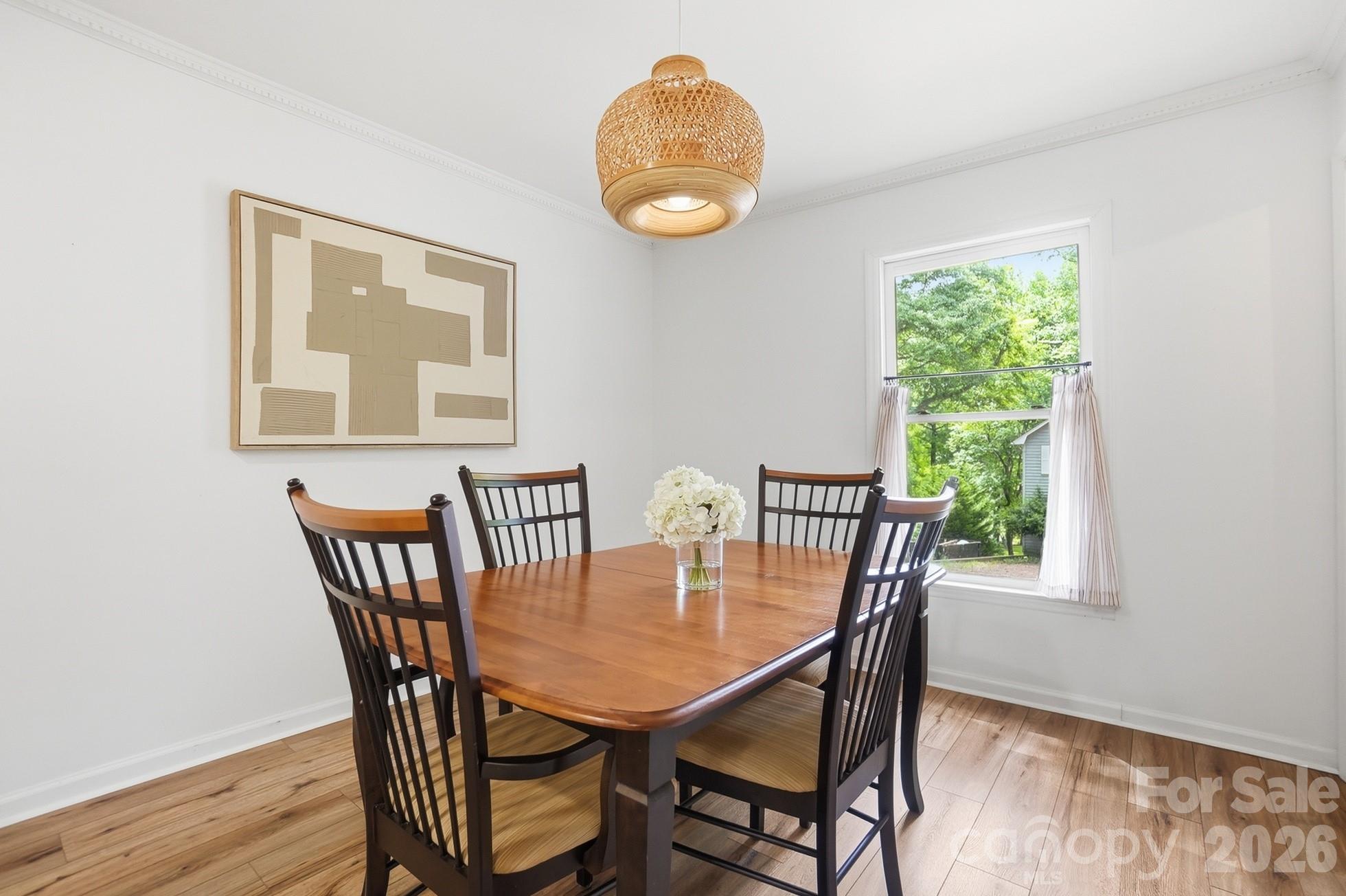 5060 Suwarrow Circle Tega Cay, SC 29708 - Photo 13 of 34 a view of a dining room with furniture and wooden floor