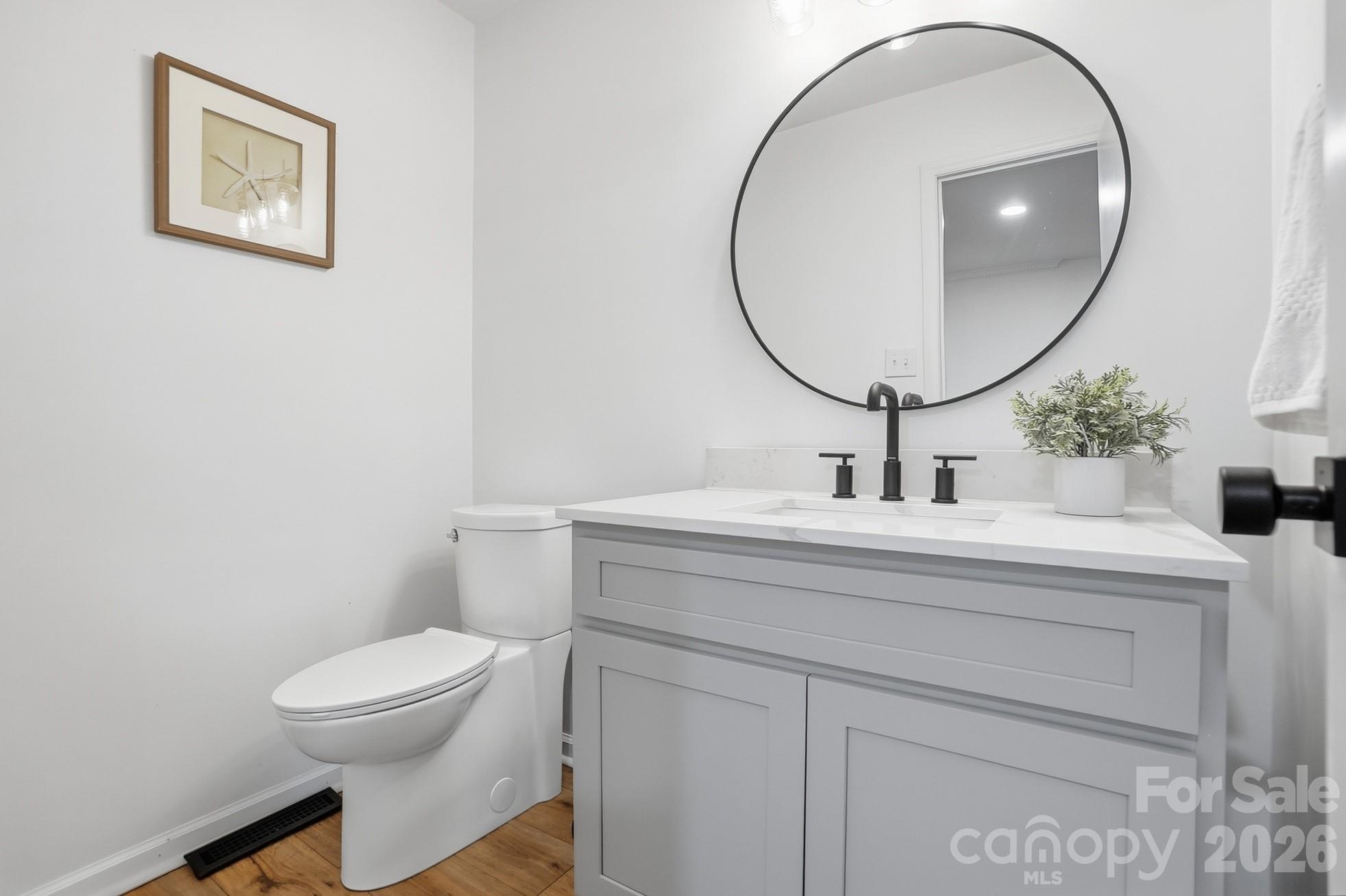 5060 Suwarrow Circle Tega Cay, SC 29708 - Photo 15 of 34 a bathroom with a toilet a sink and mirror