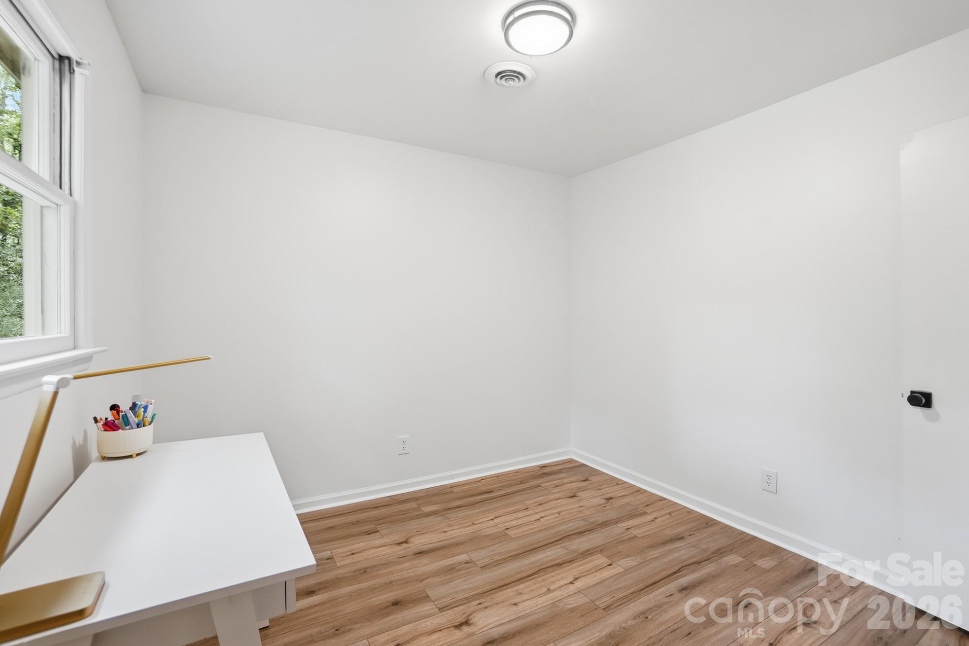 5060 Suwarrow Circle Tega Cay, SC 29708 - Photo 26 of 34 a view of a room with wooden floor and window