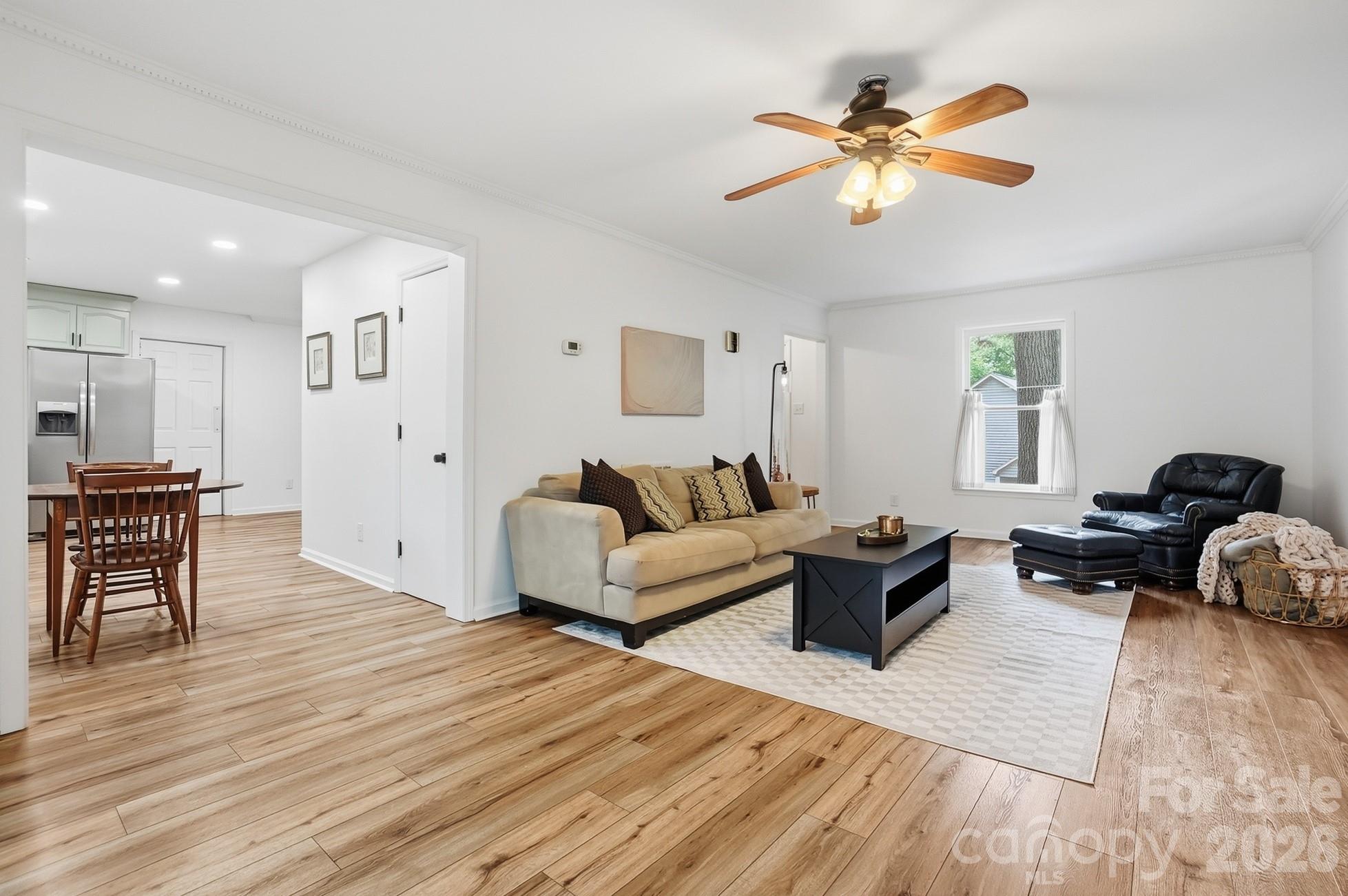 5060 Suwarrow Circle Tega Cay, SC 29708 - Photo 5 of 34 a living room with furniture and a wooden floor
