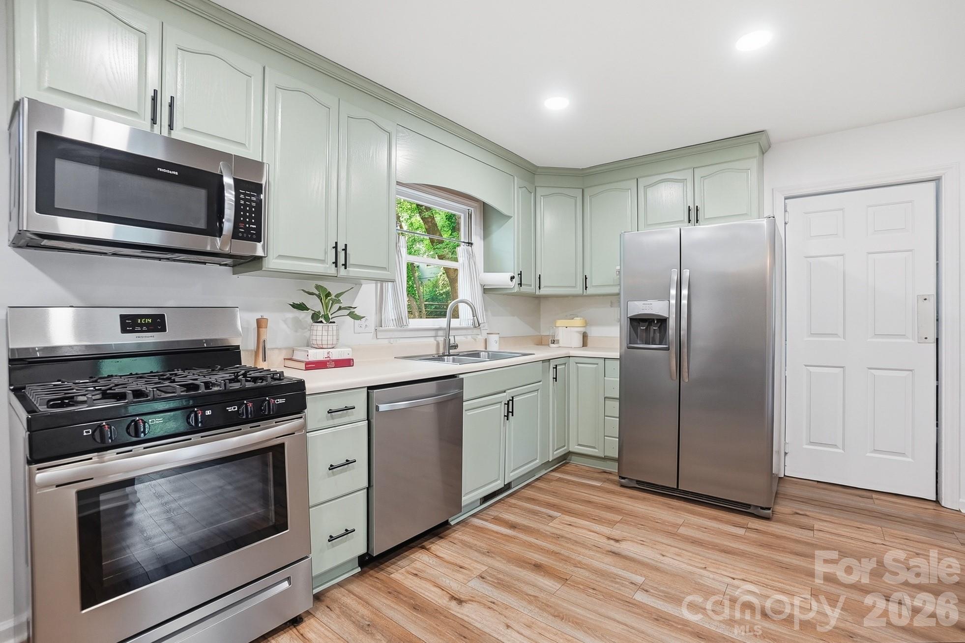 5060 Suwarrow Circle Tega Cay, SC 29708 - Photo 9 of 34 a kitchen with stainless steel appliances granite countertop a stove a refrigerator and a microwave