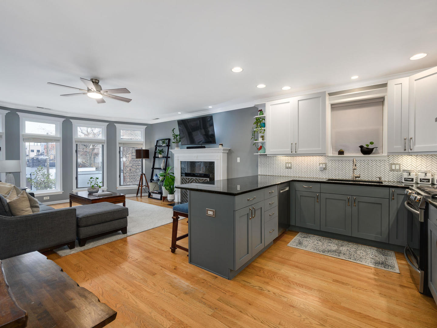 1012 North Wood Street, Unit 2 Chicago, IL 60622 - Photo 2 of 21 a kitchen with stainless steel appliances granite countertop a refrigerator a sink dishwasher a stove with wooden cabinets and floor