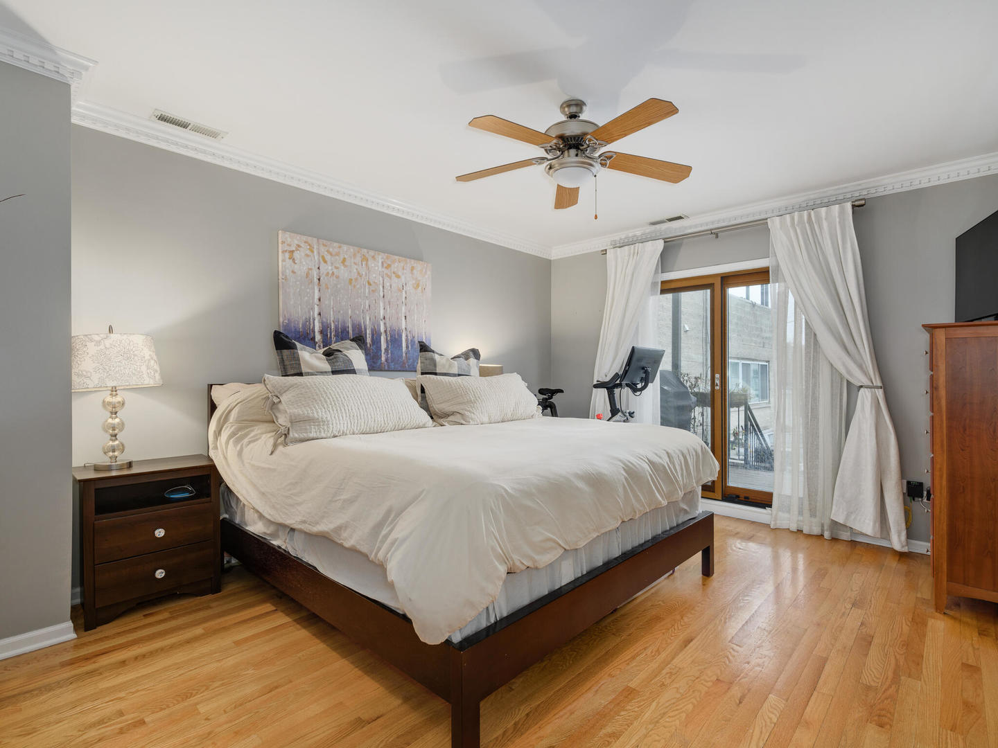 1012 North Wood Street, Unit 2 Chicago, IL 60622 - Photo 12 of 21 a bedroom with a large bed and a chandelier