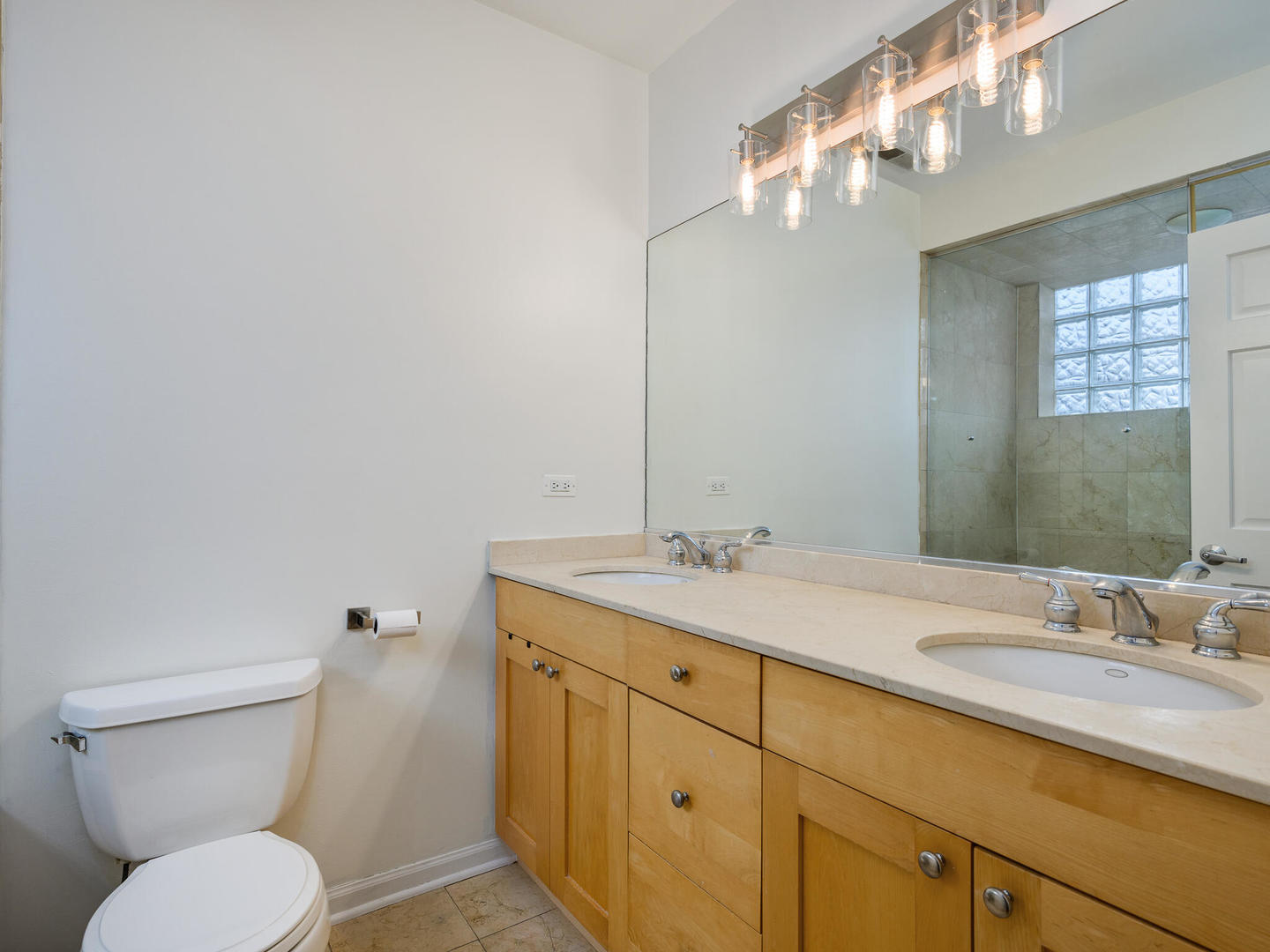 1012 North Wood Street, Unit 2 Chicago, IL 60622 - Photo 13 of 21 a bathroom with a granite countertop toilet sink and mirror