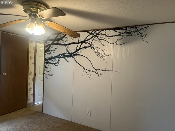 a bathroom with a shower and a fan