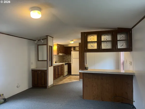 a view of kitchen with furniture and large window