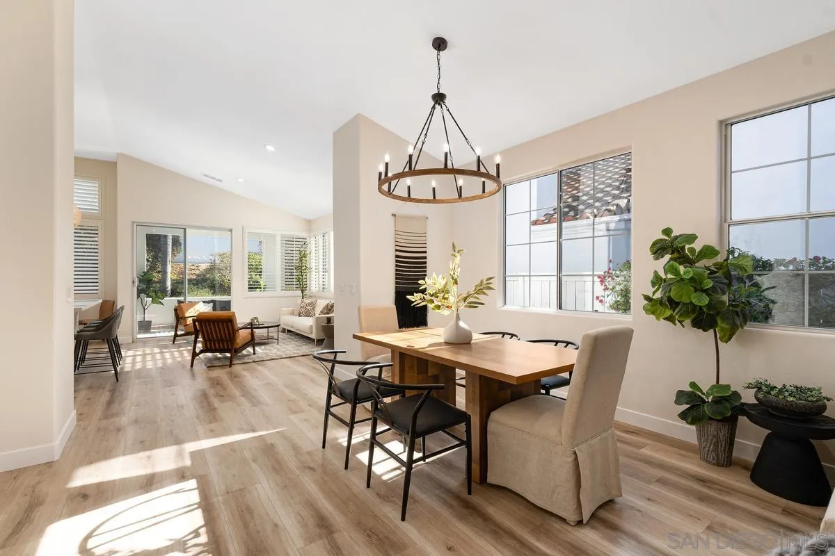 6027 Dassia Way Oceanside, CA 92056 - Photo 11 of 45 a view of a dining room with furniture window and wooden floor