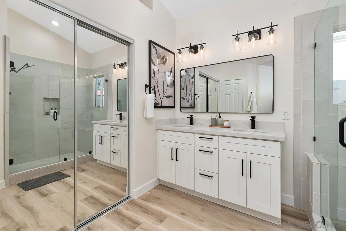 6027 Dassia Way Oceanside, CA 92056 - Photo 22 of 45 a spacious bathroom with a shower sink and mirror