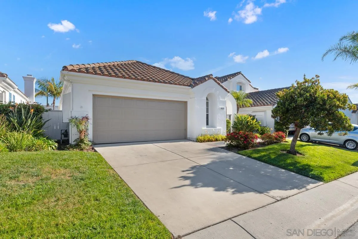 6027 Dassia Way Oceanside, CA 92056 - Photo 4 of 45 a front view of a house with a yard and garage