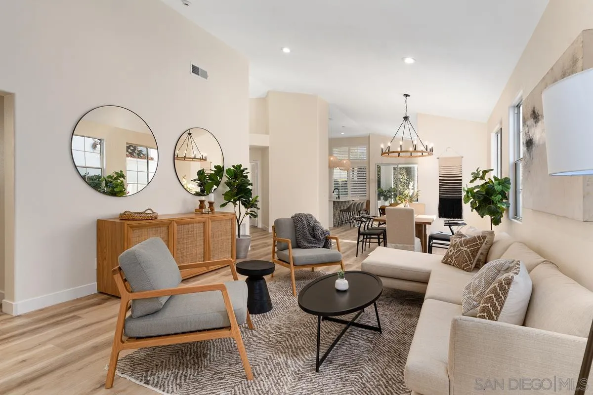 6027 Dassia Way Oceanside, CA 92056 - Photo 8 of 45 a living room with furniture a rug and a chandelier