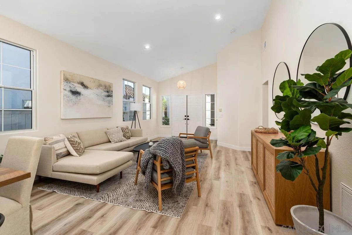 6027 Dassia Way Oceanside, CA 92056 - Photo 10 of 45 a living room with furniture a chandelier and a potted plant