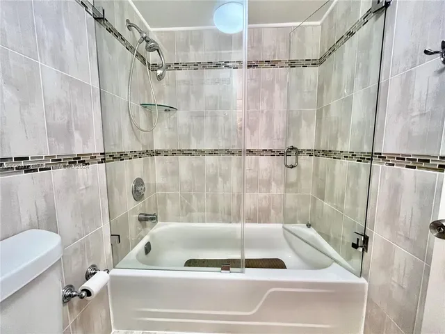 a bathroom with a shower and a bathtub