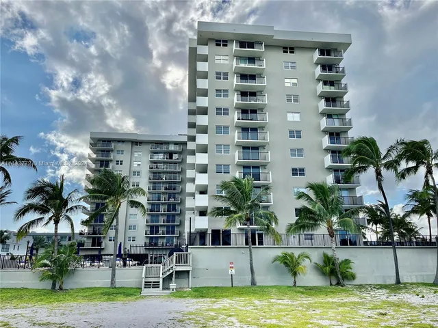 a house view with swimming pool and palm trees