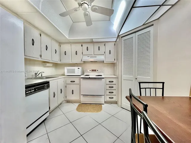 a kitchen with stainless steel appliances cabinets and a window