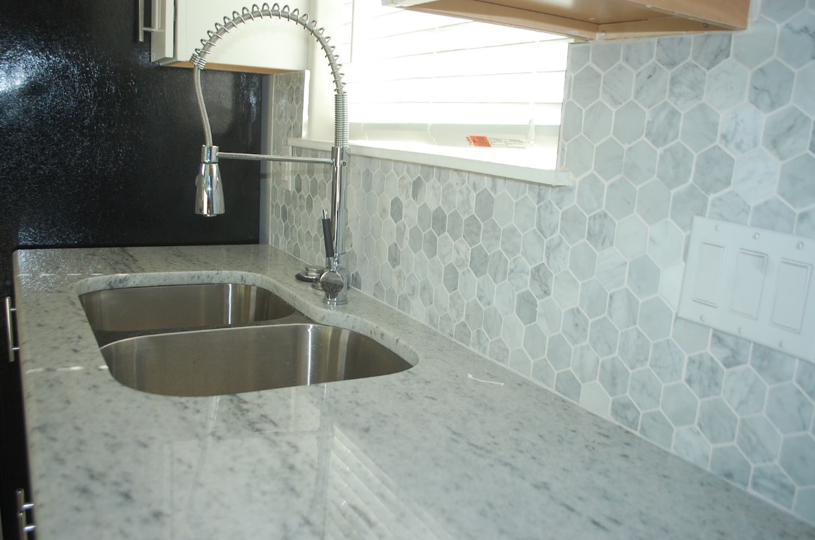 1707 Garden Street, Unit B Austin, TX 78702 - Photo 21 of 33 Kitchen with light stone countertops, tile patterned flooring, and backsplash