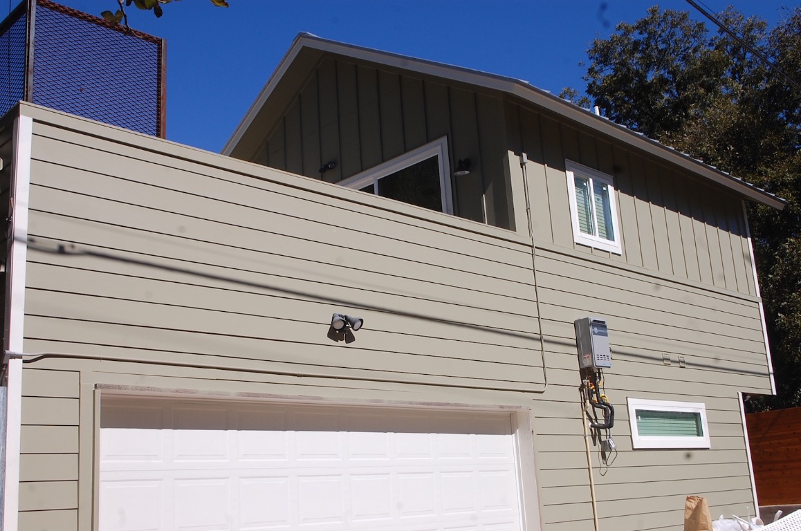 1707 Garden Street, Unit B Austin, TX 78702 - Photo 27 of 33 View of side of property with board and batten siding and an attached garage